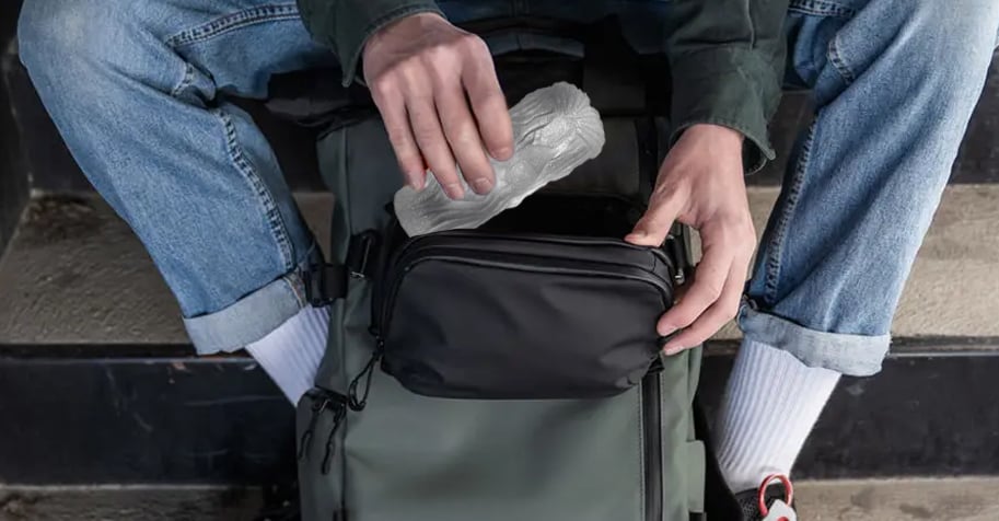 man putting a pocket pussy inside his traveling bag